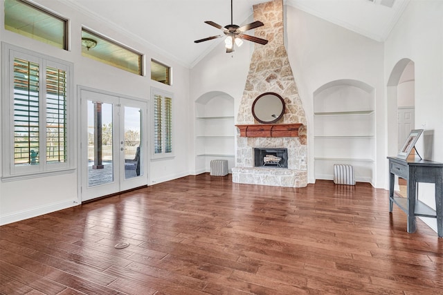 unfurnished living room featuring ornamental molding, hardwood / wood-style floors, and built in features