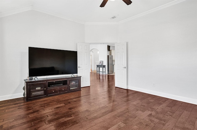 living room with arched walkways, ceiling fan, ornamental molding, and dark wood finished floors