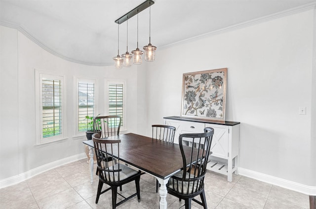 dining space with crown molding, baseboards, and light tile patterned floors