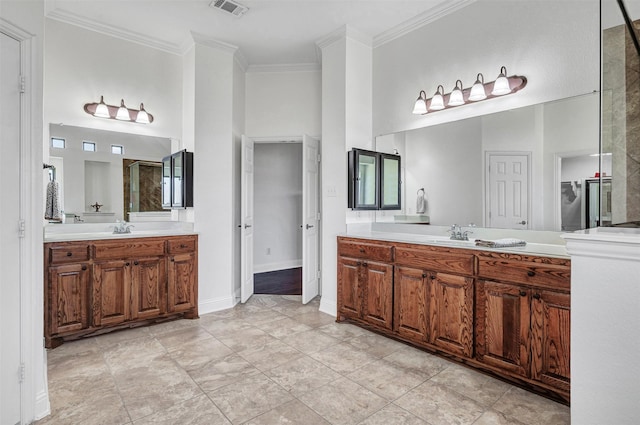 full bath with crown molding, visible vents, two vanities, and a sink