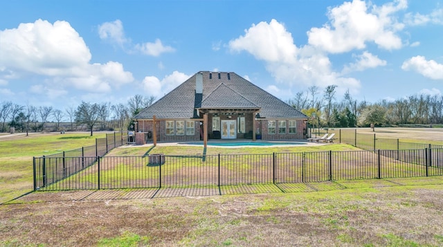 view of front of property featuring a fenced in pool, a patio, fence, a front yard, and brick siding