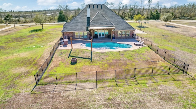 view of swimming pool featuring a fenced in pool, fence, a patio, and a yard