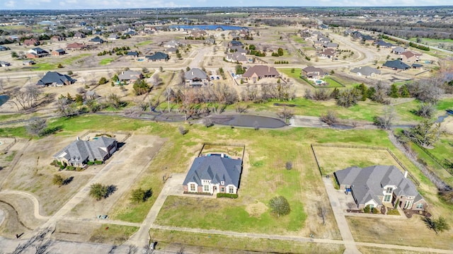 birds eye view of property featuring a water view and a residential view