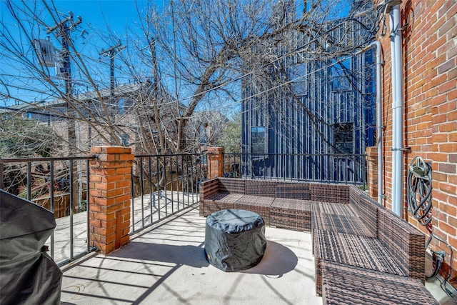 view of patio featuring a balcony