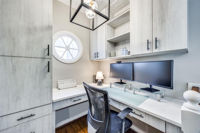 office space featuring dark wood-style floors and built in desk