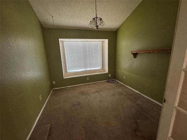 carpeted spare room with baseboards, a textured ceiling, and a textured wall