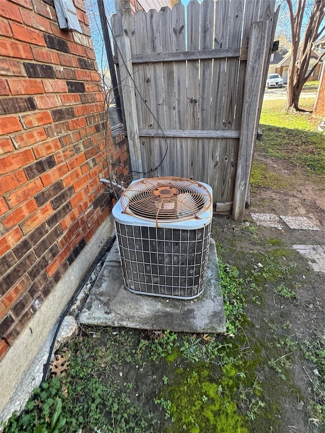 exterior details with central AC unit and brick siding