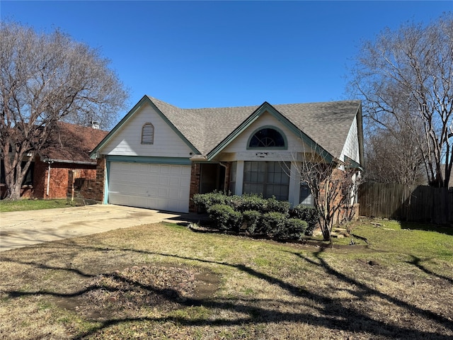 view of front of house featuring driveway, an attached garage, fence, and a front yard