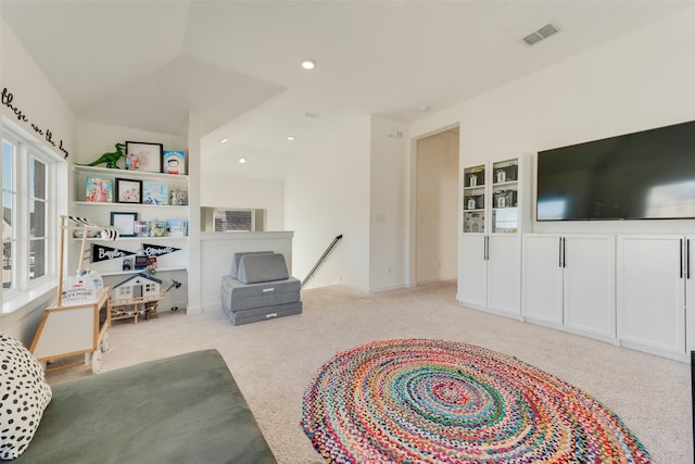 living room with recessed lighting, visible vents, and light colored carpet