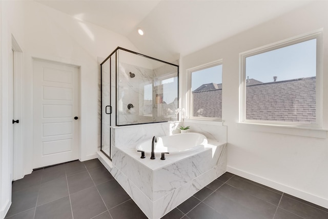 bathroom featuring a garden tub, a shower stall, vaulted ceiling, and tile patterned floors