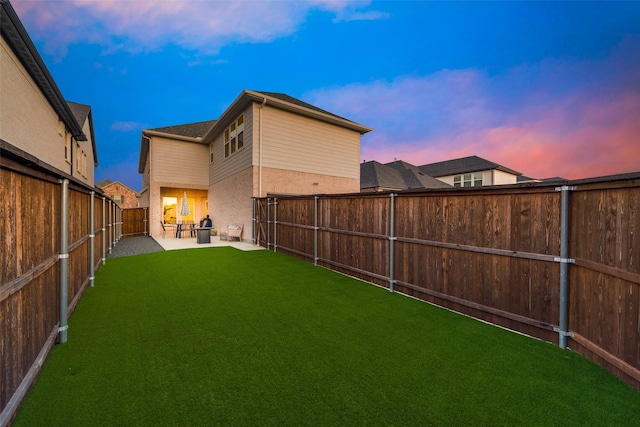 view of yard featuring a patio area and a fenced backyard