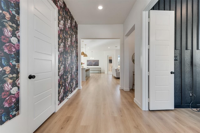 hall with light wood-type flooring, recessed lighting, baseboards, and wallpapered walls