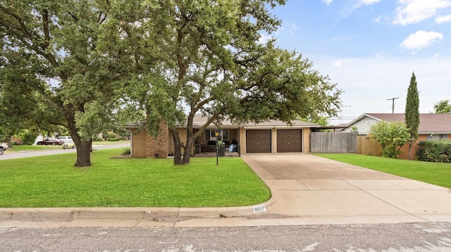 ranch-style house featuring brick siding, fence, a garage, driveway, and a front lawn