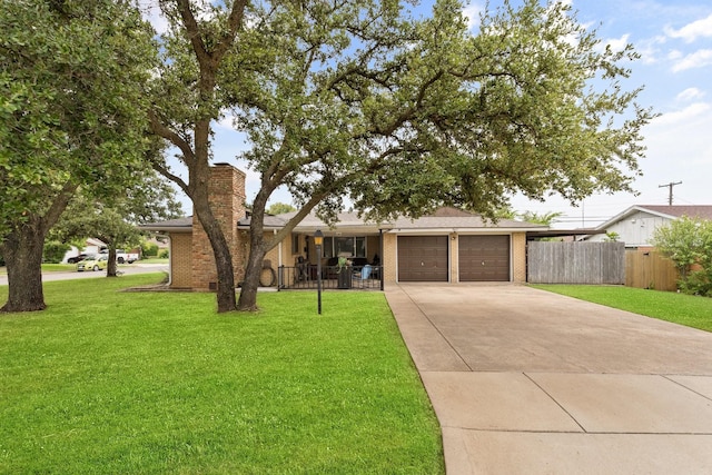 ranch-style home featuring a garage, concrete driveway, fence, a front lawn, and brick siding