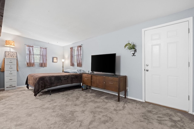 carpeted bedroom featuring baseboards