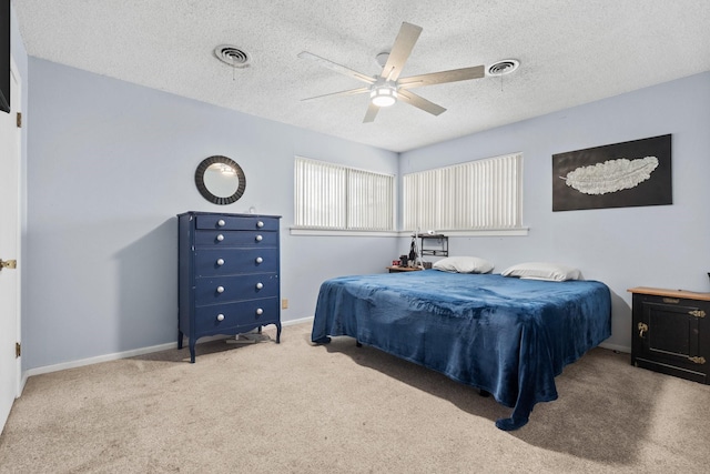 bedroom featuring visible vents, a textured ceiling, and baseboards