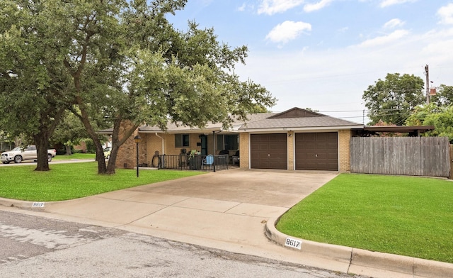 single story home featuring a garage, concrete driveway, fence, a front lawn, and brick siding