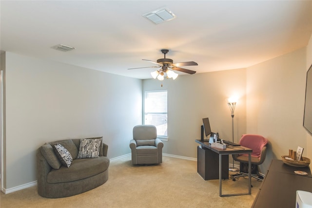 home office with visible vents, light colored carpet, and a ceiling fan