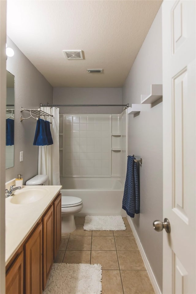 bathroom with vanity, visible vents, tile patterned flooring, a textured ceiling, and toilet