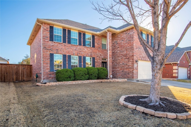 view of front facade with driveway, a garage, fence, and brick siding