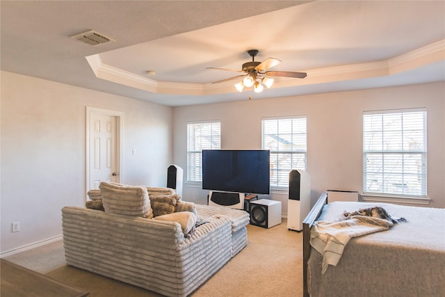 interior space featuring visible vents, a raised ceiling, light carpet, and a ceiling fan