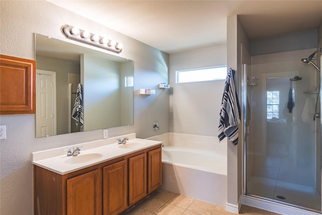 bathroom featuring a sink, a shower stall, and tile patterned flooring