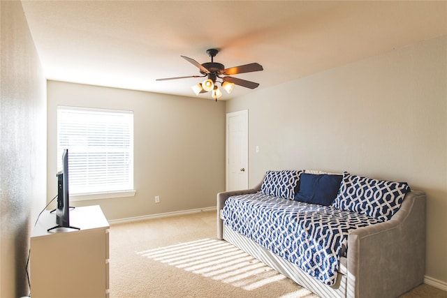 bedroom featuring ceiling fan, baseboards, and light carpet