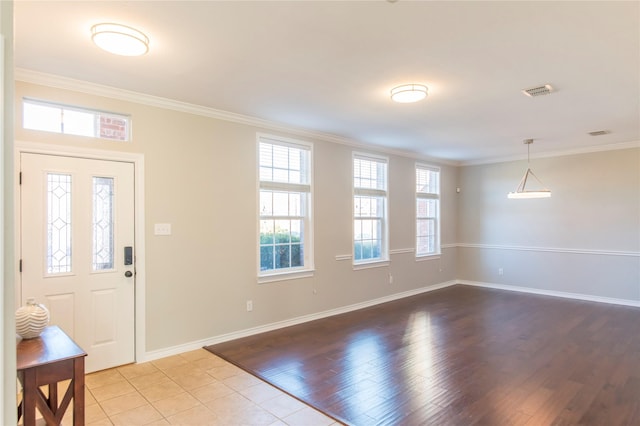 foyer featuring wood finished floors and crown molding