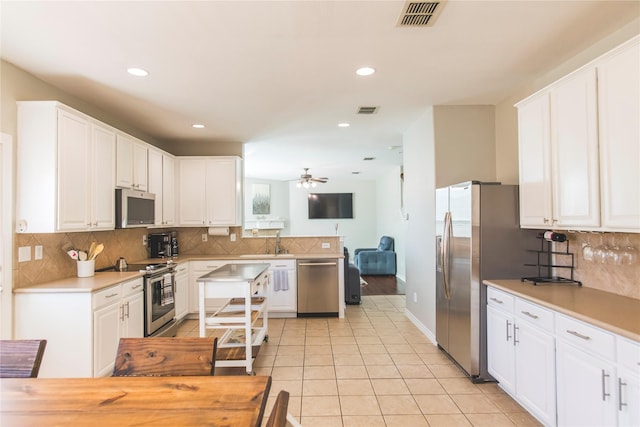 kitchen featuring visible vents, appliances with stainless steel finishes, light tile patterned flooring, white cabinets, and ceiling fan