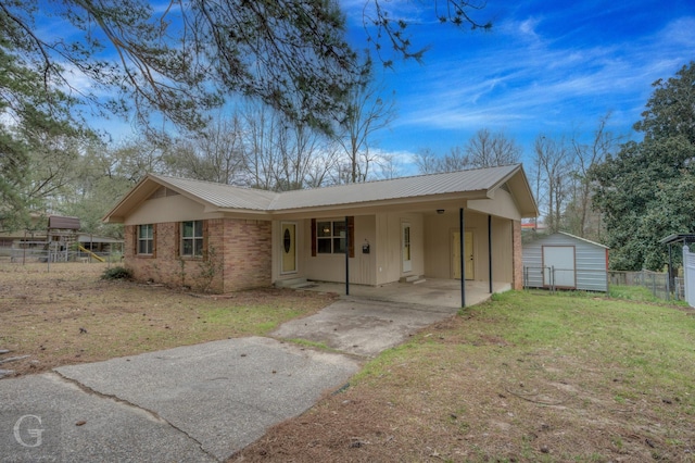 single story home featuring driveway, fence, a shed, metal roof, and a carport