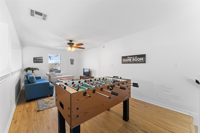 game room featuring baseboards, light wood-type flooring, visible vents, and a ceiling fan