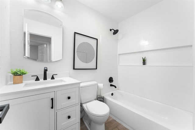 bathroom with toilet,  shower combination, wood finished floors, and vanity