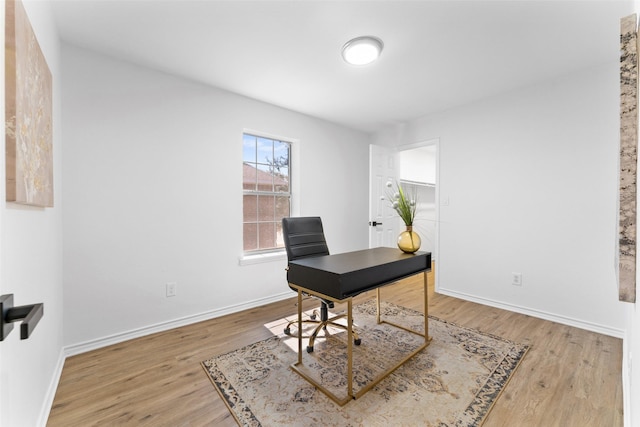 office with baseboards and wood finished floors