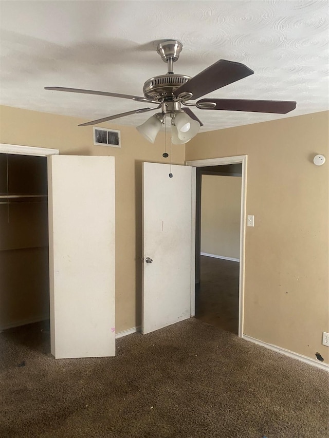 unfurnished bedroom featuring carpet, a closet, visible vents, and a ceiling fan