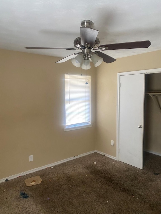 unfurnished bedroom with a ceiling fan, a closet, carpet flooring, and baseboards