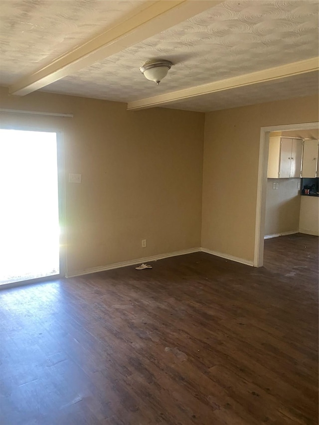 empty room featuring baseboards, dark wood-type flooring, and beamed ceiling