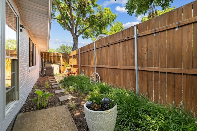 view of yard featuring a fenced backyard and central air condition unit