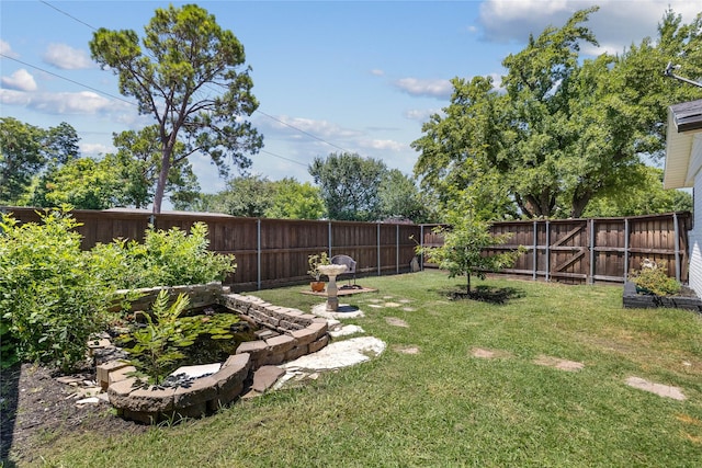 view of yard with a fenced backyard