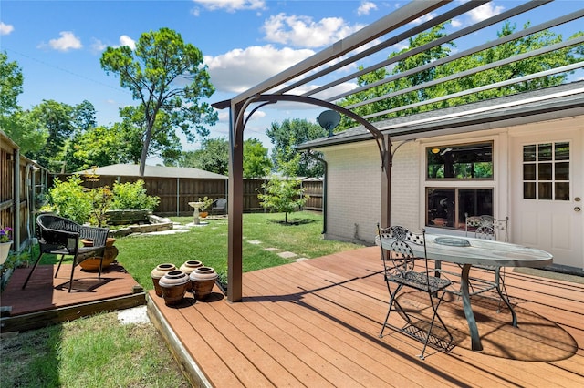 deck with outdoor dining area, a fenced backyard, a yard, and a pergola