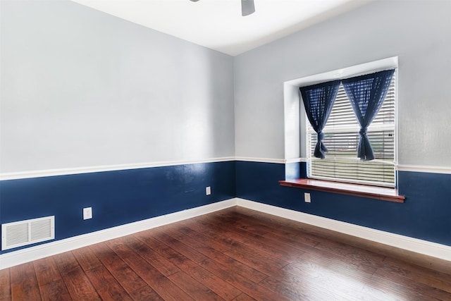 unfurnished room with ceiling fan, wood-type flooring, visible vents, and baseboards