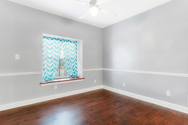 empty room with baseboards, dark wood finished floors, and a ceiling fan