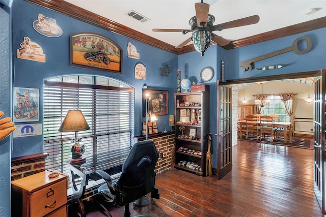 office space with visible vents, ornamental molding, wood finished floors, and ceiling fan with notable chandelier