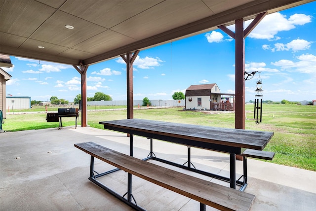 view of patio / terrace featuring fence and an outdoor structure