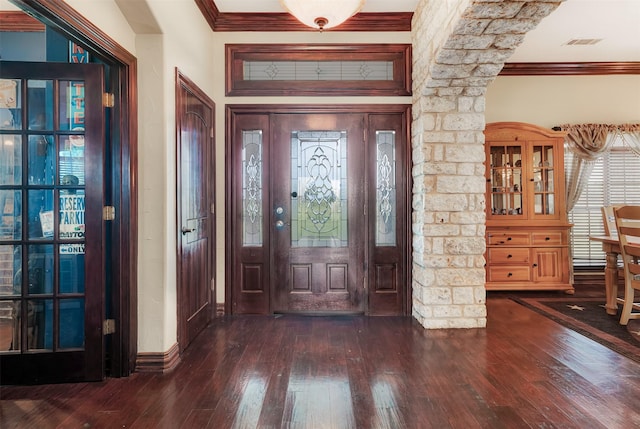 entrance foyer featuring visible vents, crown molding, baseboards, and hardwood / wood-style flooring