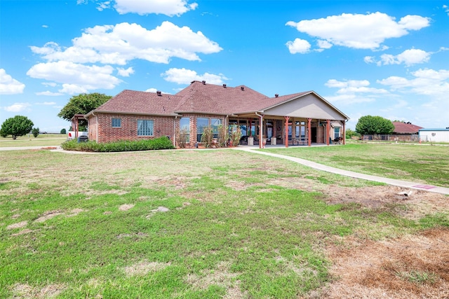 view of front of property featuring a front lawn and brick siding