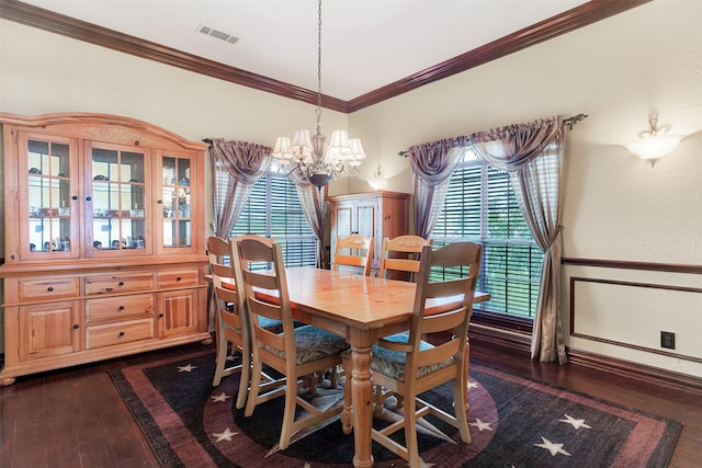 dining room featuring dark wood-style floors, a wainscoted wall, crown molding, visible vents, and a chandelier