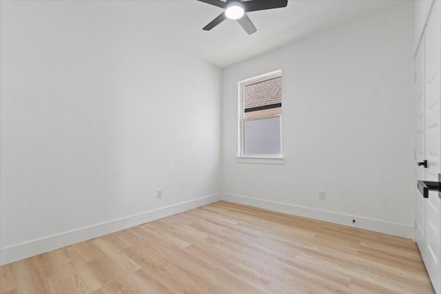 empty room with light wood finished floors, a ceiling fan, and baseboards