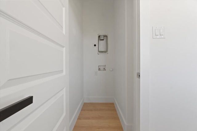 interior space featuring baseboards and wood finished floors