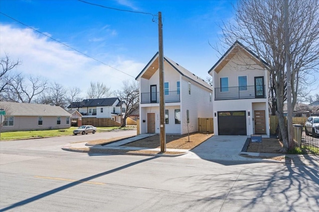 view of front of property with a balcony, a residential view, and fence