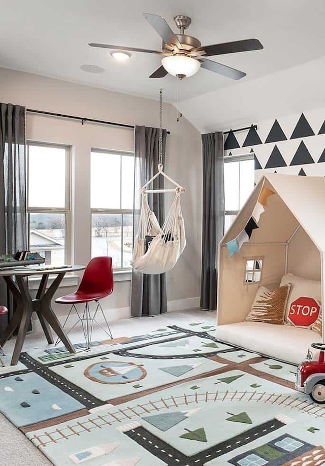 game room with a ceiling fan and baseboards